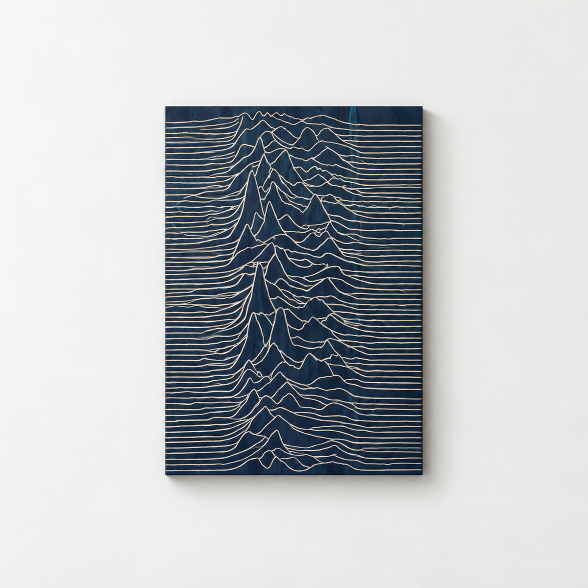 Joy Division Wall Art: Hand-Carved Wood, Abstract Line Design — front view on a light grey-white wall with a natural shadow